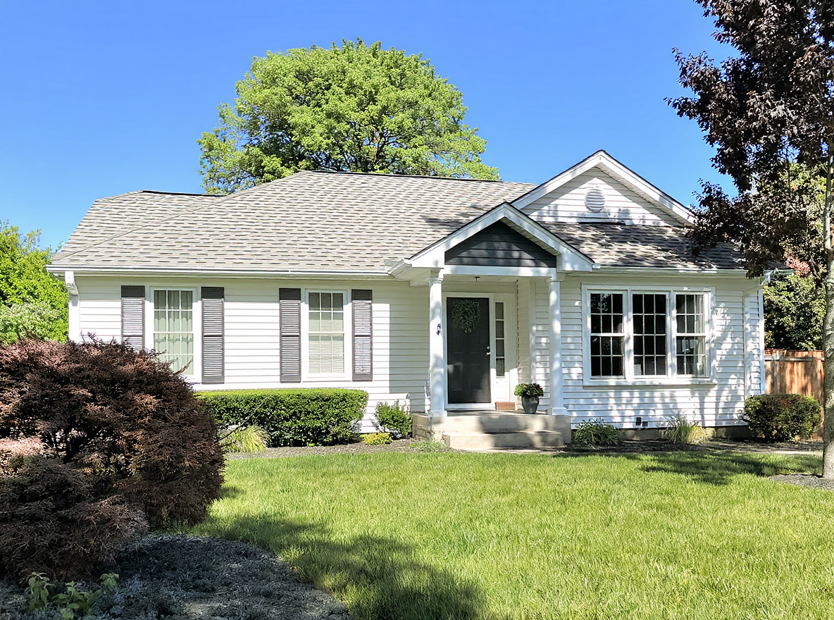 Completed residential roof replacement on a Southern ranch-style home photographed in golden hour light showing fresh charcoal architectural shingles with clean ridge cap lines and new galvanized drip edge, a finished project by a Gulf Coast roofing contractor serving Mobile and Baldwin County Alabama where properly installed six-nail pattern shingles and synthetic underlayment protect homes through decades of 140 mph wind events and 66 inches of annual rainfall